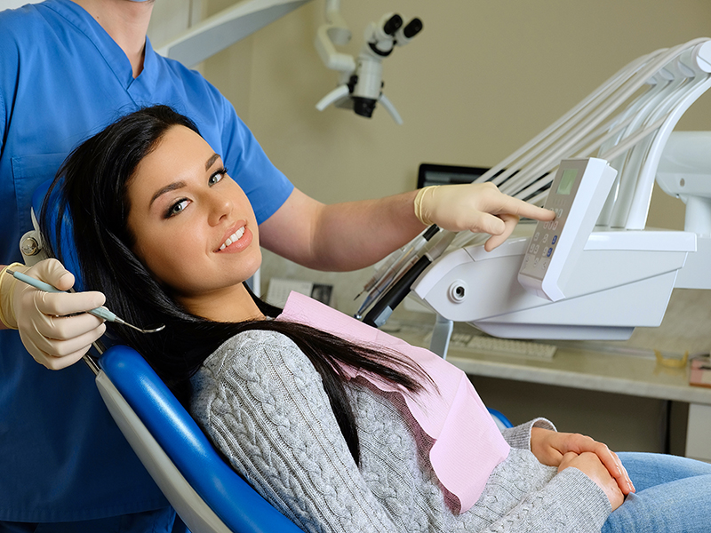 Dentist curing a female patient. Dentistry care visit